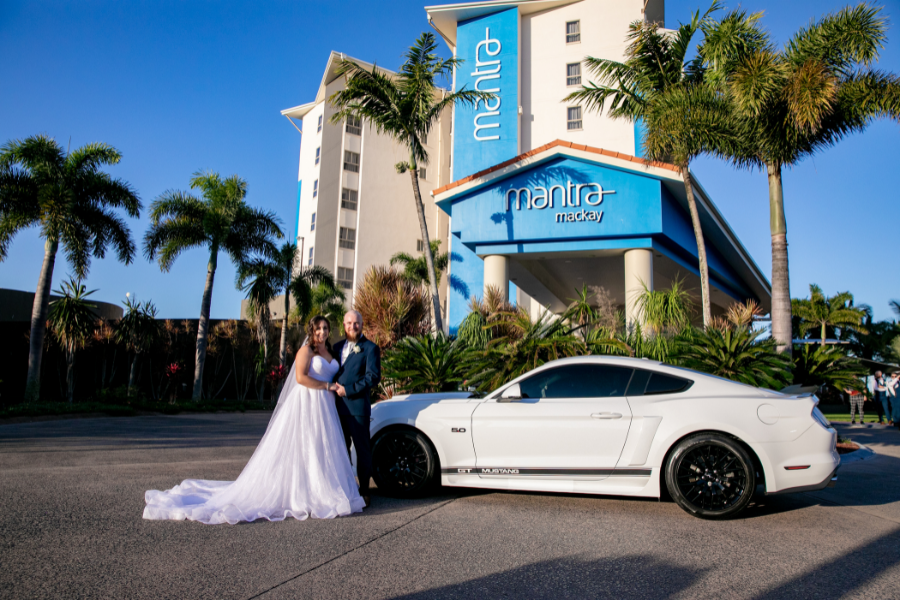 Newly married couple outside Mantra Mackay