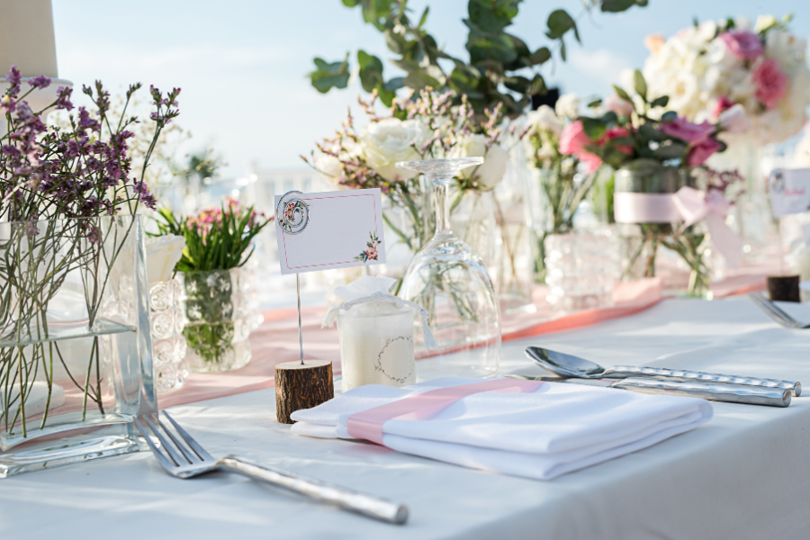 Waterfront wedding table styled with florals